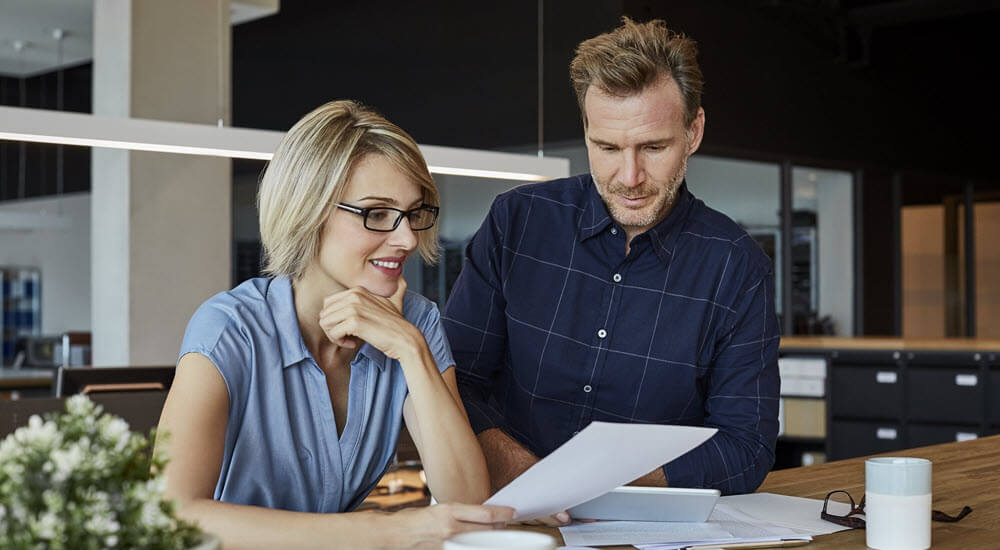 Business people looking at document at desk