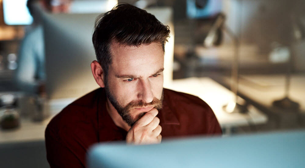 Young man looking at computer screen